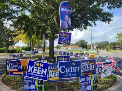 Campaign signs outside the Orange County Library's Alafaya Branch on Aug. 9, 2022, an early voting site